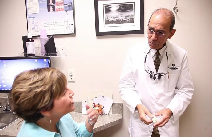 Dr. Chenet explaining treatment options to a patient in the treatment room.